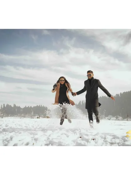Your pre-wedding shoot should be fun. In the snowy landscapes of Kashmir, we captured this moment of pure, unscripted joy. It’s these candid, playful memories that truly show a couple's connection.