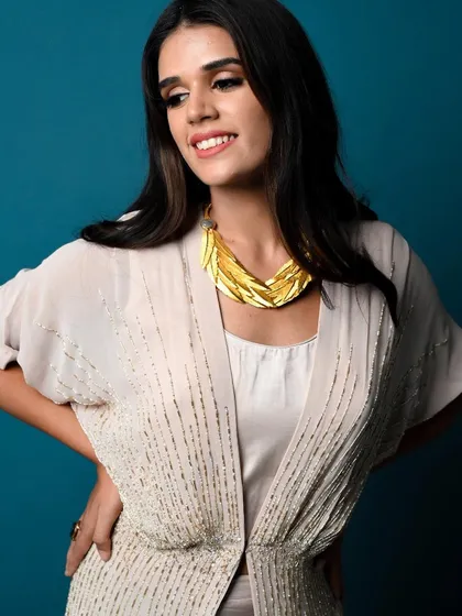 A close-up of one of the Diwali looks, focusing on the statement gold necklace that elevates the entire ensemble.