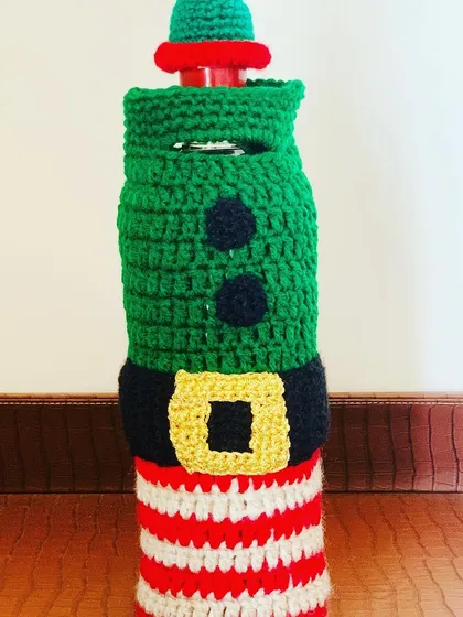A close-up of the striped elf bottle cover, perfect for adding a touch of whimsy.