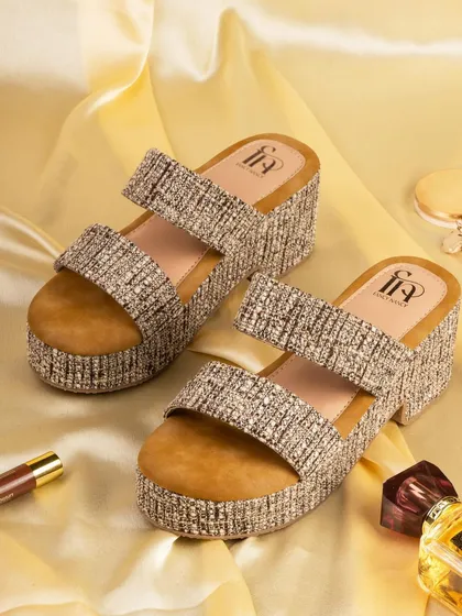 A pair of tweed-patterned platform sandals for Fancy Nancy. The styling with a soft, golden background gives the footwear a chic and sophisticated look.
