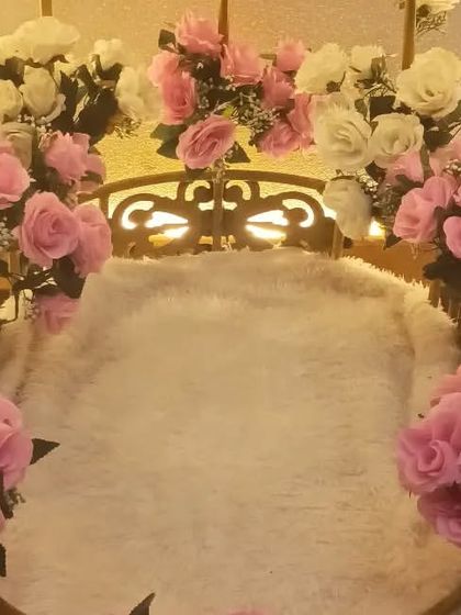 A special decorative swing adorned with pink and white roses, created for a Barbie-themed birthday party.