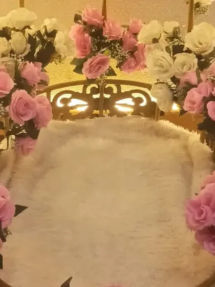 A special decorative swing adorned with pink and white roses, created for a Barbie-themed birthday party.
