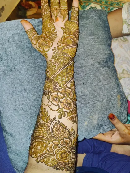 A beautiful party henna design that covers the full arm, suitable for a bridesmaid or close family member.