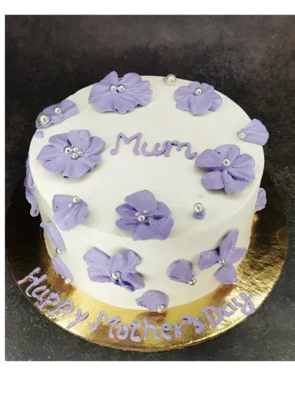 A lovely floral cake for "Mum" on Mother's Day. This mixed fruit cake is decorated with pretty purple piped flowers.