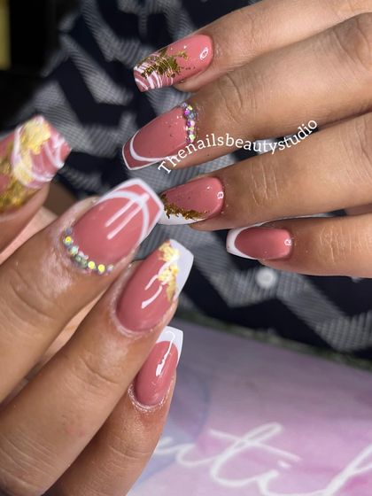 A closer look at this Pinterest-inspired French manicure, highlighting the combination of gold foil and spider gel art.