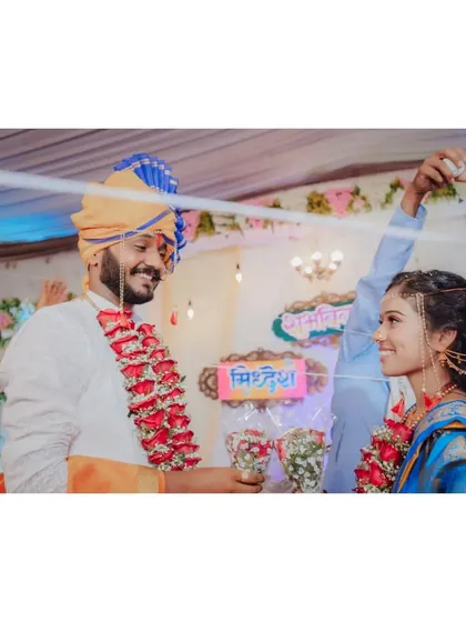 A candid shot of the couple during a wedding ritual, sharing a smile. Capturing these connections is my specialty.