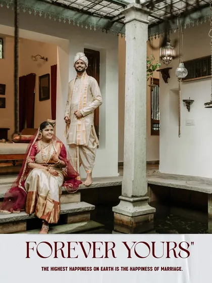 A classic wedding portrait of the couple in a traditional South Indian home.