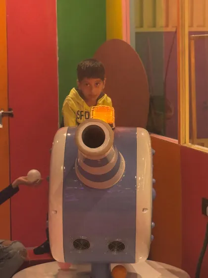 Manning the ball cannon. This is a fun and interactive feature within our play structure where kids can safely launch soft balls.