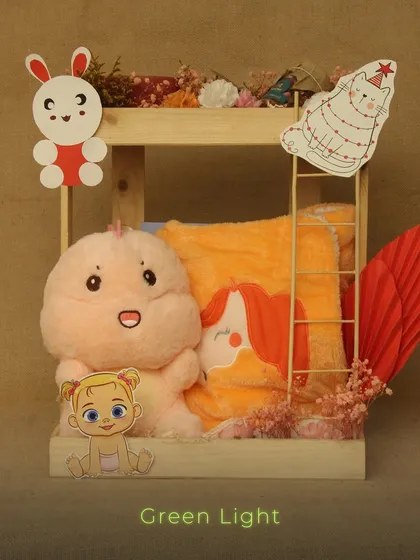 A cute and playful hamper for a child's gift. This wooden crate includes a soft plush toy and a character-themed towel, decorated with fun cutouts.