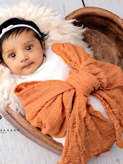 A beautiful, expressive portrait of an awake baby in our popular heart bowl prop.