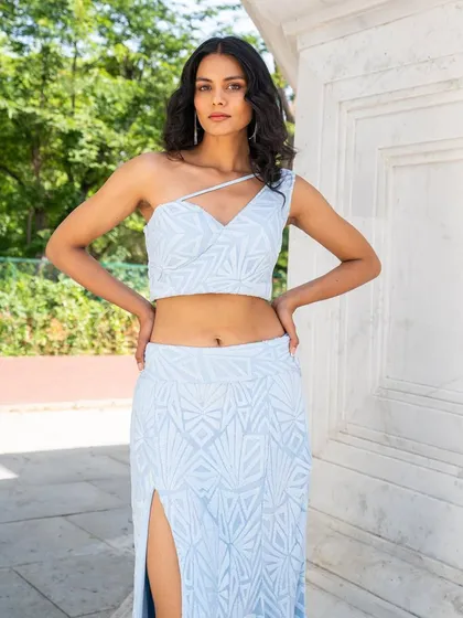 Get your Indo-western fix. This powder blue co-ord set with a one-shoulder top and slit skirt is a great example of the modern, easy-to-wear styles we offer.