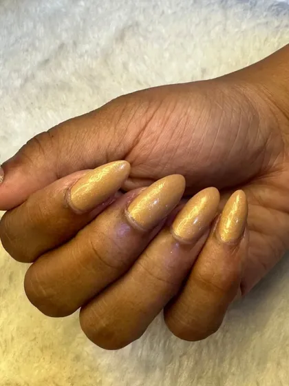 A close up of the nude shimmer nails, showing the beautiful almond shape and the delicate sparkle.