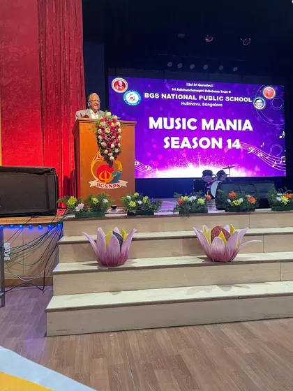 A speaker addresses the audience at the BGSNPS Music Mania competition. Events like these are vital for fostering a culture of musical appreciation.