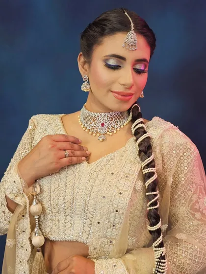 An eyes-closed shot to display the detailed eyeshadow work and flawless base.