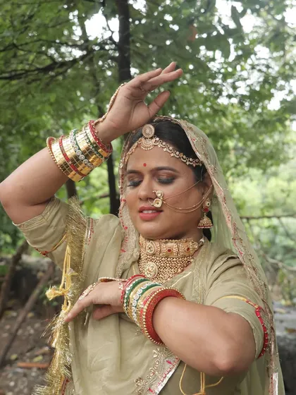 A dynamic pose capturing the artistry of the makeup and the flow of the traditional costume.