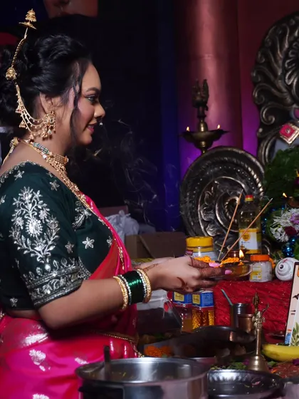 A side profile showing the intricate hairstyle and jewelry chosen for this festive Marathi look.
