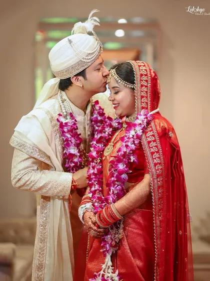 A tender kiss on the forehead during the wedding ceremony. This classic, romantic gesture is a beautiful expression of love and care between the couple.