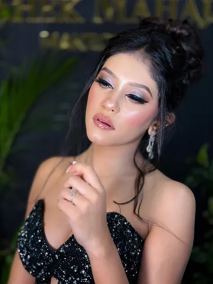 An elegant pose with eyes closed, highlighting the silver eyeshadow.