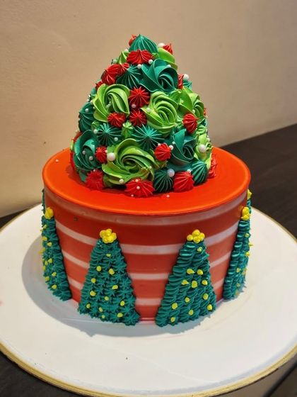 A festive Christmas cake designed to look like a Christmas tree. This 2kg cake is perfect for holiday parties.