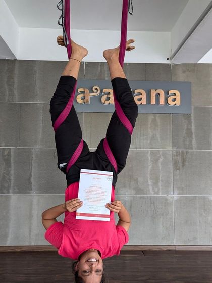 Celebrating certification with a classic inverted pose. This is a testament to her hard work and newfound confidence.