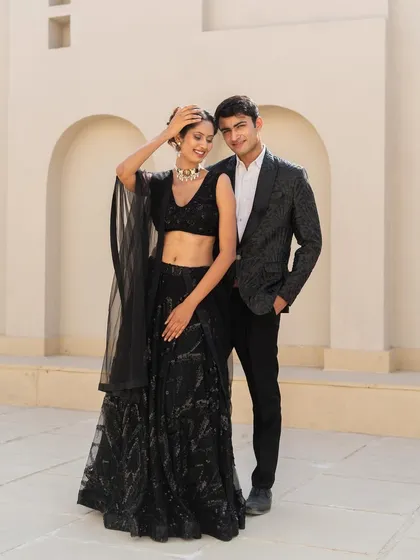 We have menswear too. Come get fun outfits for you and your partner, like this black sequin lehenga and a stylish black tuxedo jacket.