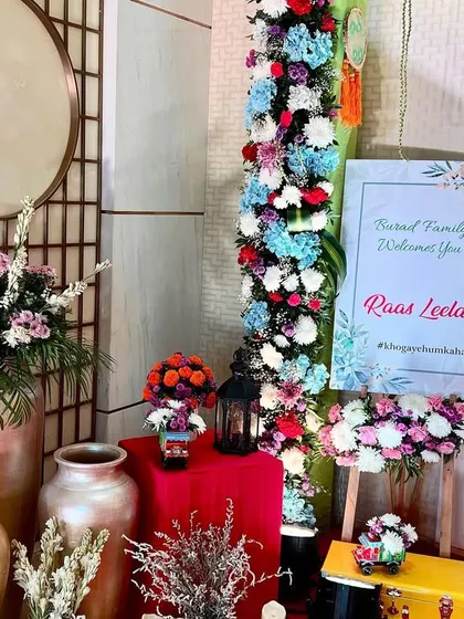 A detailed shot of the welcome area, with a custom sign, floral arrangements, and decorative vases setting a warm and inviting tone.
