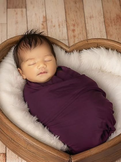A heart-shaped prop perfectly frames this sleeping baby, symbolizing the love that surrounds them. I have a wide variety of safe and beautiful props like this to personalize your newborn's photoshoot.