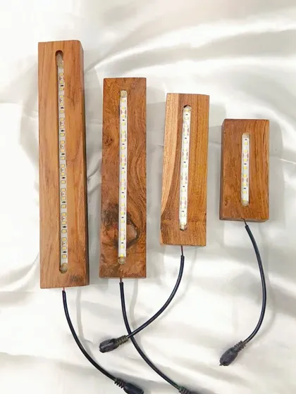 Our teakwood LED light stands provide a warm, beautiful glow for your finished resin pieces. This image shows the variety of sizes we offer to fit different projects.