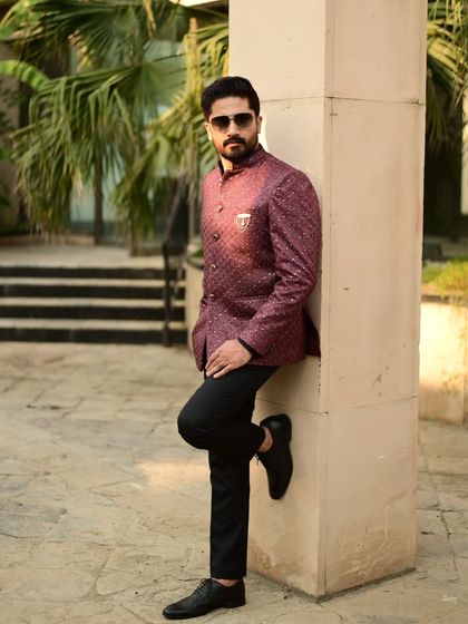 A stylish Jodhpuri suit in a rich wine color. This bandhgala jacket is perfect for formal events, offering a sophisticated alternative to a traditional tuxedo.