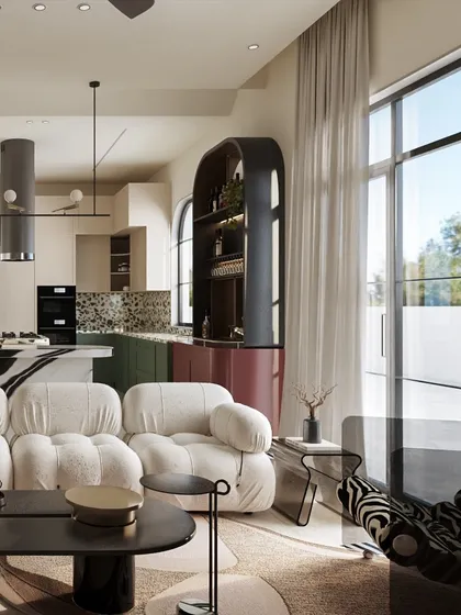 An open view from the living room into the kitchen and bar area. The design maintains a cohesive feel through a shared palette of deep reds and greens, while large windows flood the space with natural light.
