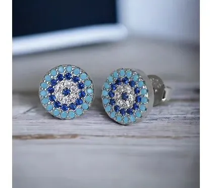 These multi-colored evil eye studs feature concentric circles of blue, turquoise, and white stones for a vibrant and protective design.