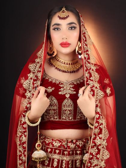 The quintessential bridal pose with the veil. The makeup here is strong enough to look beautiful even through the sheer fabric of the dupatta.