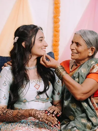 A tender moment between the bride and her grandmother during the Mehndi ceremony. These multi-generational photos are so important and full of love.