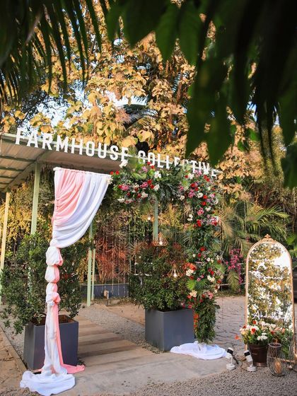 A collection of stunning wedding setups at The Farmhouse Collective. You can see the venue's versatility, from elegant morning ceremonies with floral mandaps to glamorous evening receptions with fairy lights and chic decor. This space is a blank canvas for your dream outdoor wedding in Bengaluru.