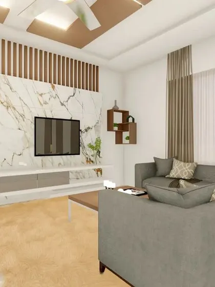 A wide view of a living area design for a client in Tiptur, featuring a marble-clad TV wall with vertical wood slats and a comfortable L-shaped sofa, creating a warm and inviting atmosphere.