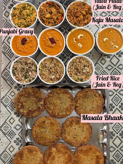 A spread of Jain and regular dishes, including Jain Tawa Pulao, Jain Fried Rice, and Jain Kaju Masala.