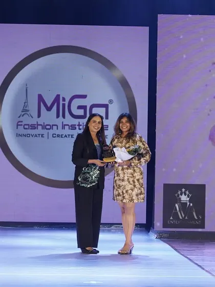 A moment of immense pride, being felicitated on stage at the MIGA Fashion Show. This award is a culmination of years of dedication, and I'm so grateful for the opportunity and the support from my family and students.