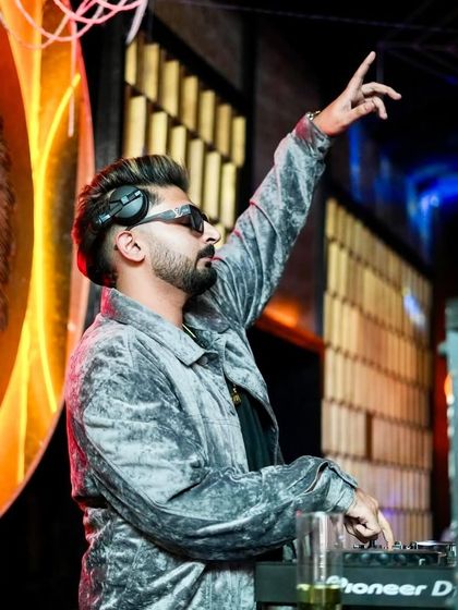 Hand raised, connecting with the music and the crowd.