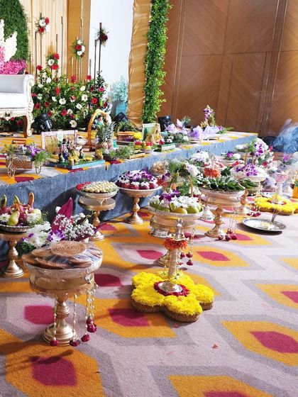 Another perspective of the grand Sreemantham display, focusing on the items arranged on the floor. I use floral arrangements and lamps to complement the platters.