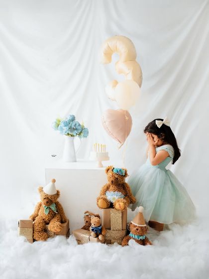 A cute peek-a-boo moment during her third birthday photoshoot. Even the shy moments are precious.