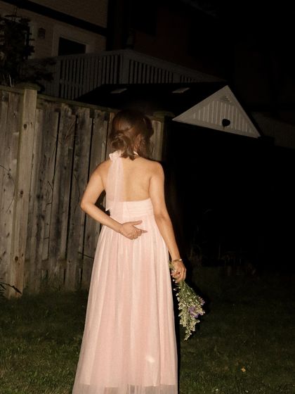 A shot from behind, showing the back detail of the pink dress.