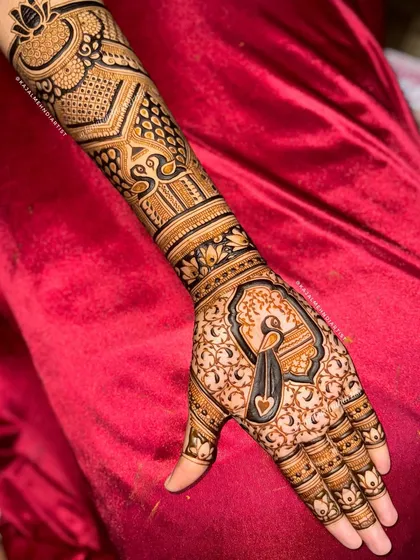The full arm view of the peacock design, showing the intricate patterns on the forearm.