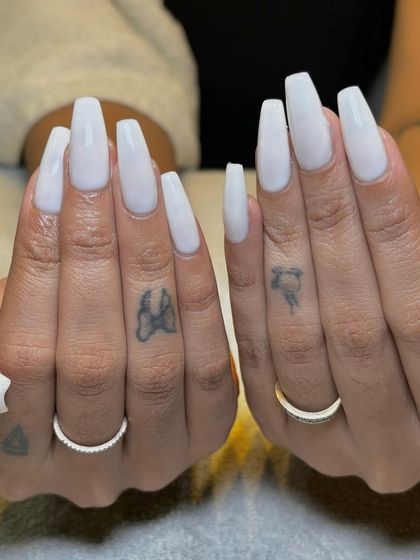 Another shot of the milky white Gel-X nails, showing off the crisp coffin shape and flawless finish.