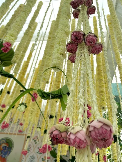 A close-up of the delicate floral hangings, featuring jasmine and lotus buds, a signature element of our traditional South Indian decor.
