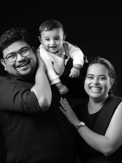 A moment of pure family joy, captured in a timeless black and white studio portrait. The genuine laughter and interaction make this a perfect example of the happy, candid moments we love to freeze in time.