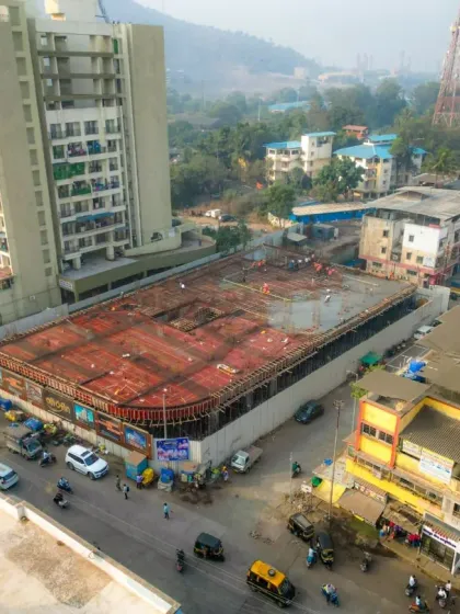 Another perspective of the urban construction site, highlighting its proximity to adjacent buildings and traffic flow. This helps in logistics planning and creating marketing materials that showcase the location.