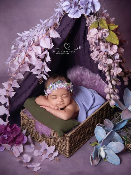 A floral tent in shades of purple. The rich color and the cascade of wisteria-like flowers create a truly magical and enchanting hideaway.