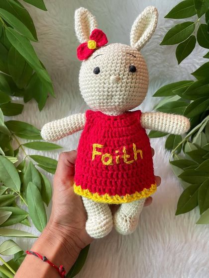 This bunny in a bright red and yellow dress is personalized with the name "Faith". The vibrant colors make her so cheerful and fun.