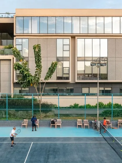 The annexe for the Koramangala Club in Bangalore was designed to seamlessly integrate with the existing campus. This view of the tennis courts against the new building highlights our ability to design large-scale recreational spaces that are both functional and contextually sensitive, enhancing community life.