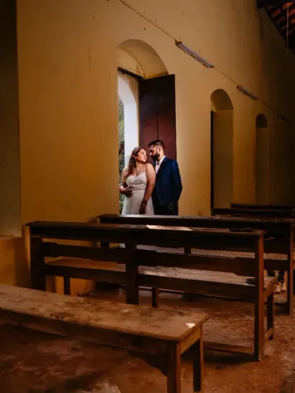 An intimate moment inside an abandoned chapel on St. Jacinto island in Goa. The rustic interior and soft window light create a quiet, contemplative mood for this unique destination portrait.